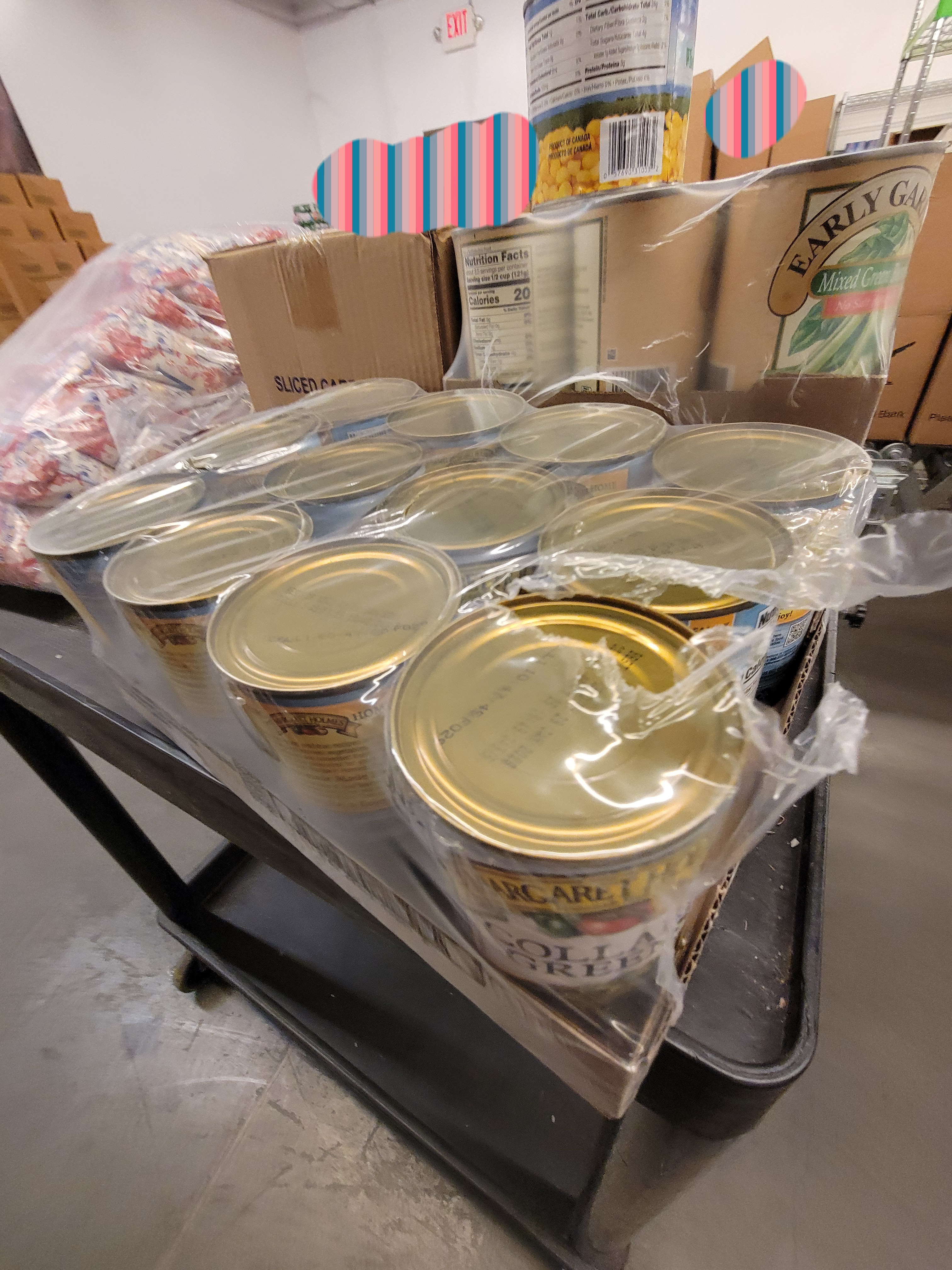 Shelf cart with food products on top.